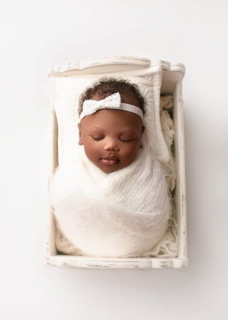 newborn photography studio atlanta, newborn photos near me, atlanta newborn photography, affordable newborn photography, timeless family photographer, family photographer atlanta ga, baby girl posed on white backdrop in a crate for newborn photos