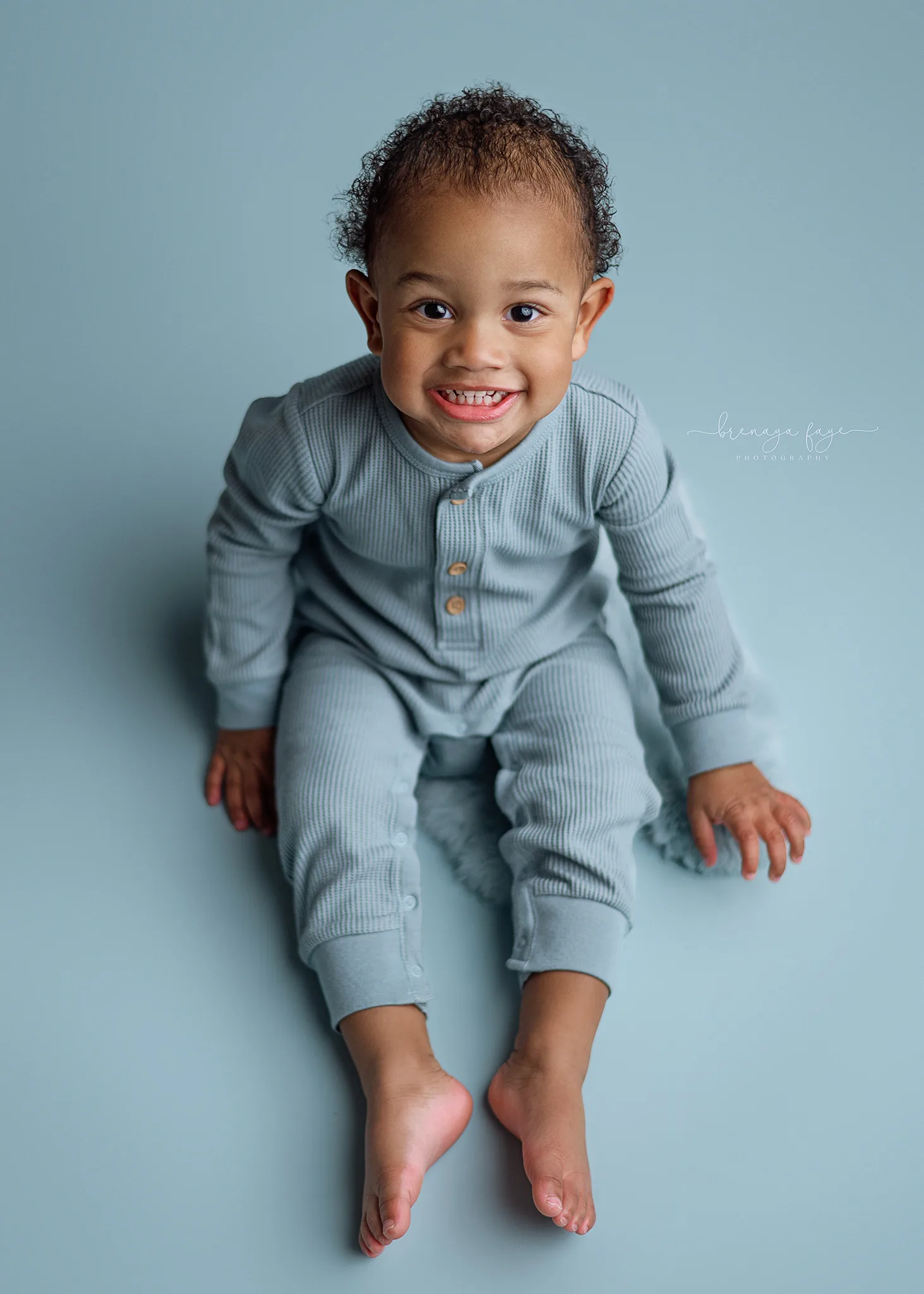 boy in blue posed for his birthday photoshoot in lincoln nebraska, omaha baby photography, milestone session near me, nebraska portrait photographer, simple baby photos hickman ne
