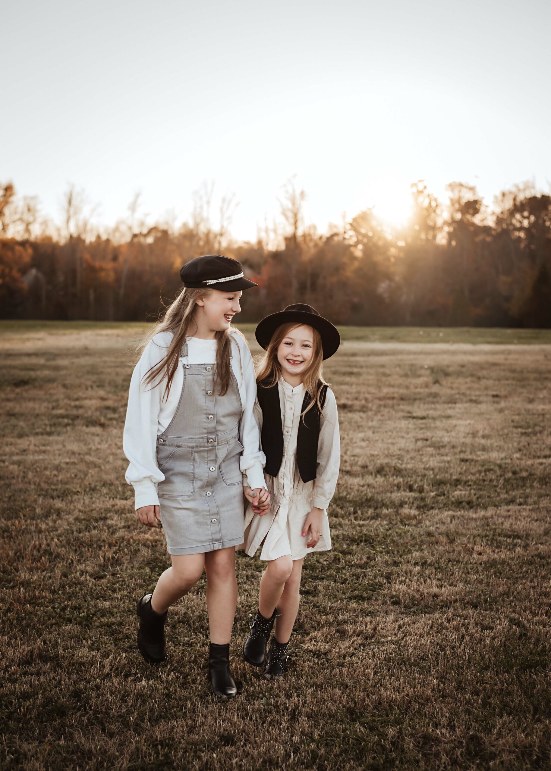sisters holding hand during photo session in lincoln nebraska, fall family photos