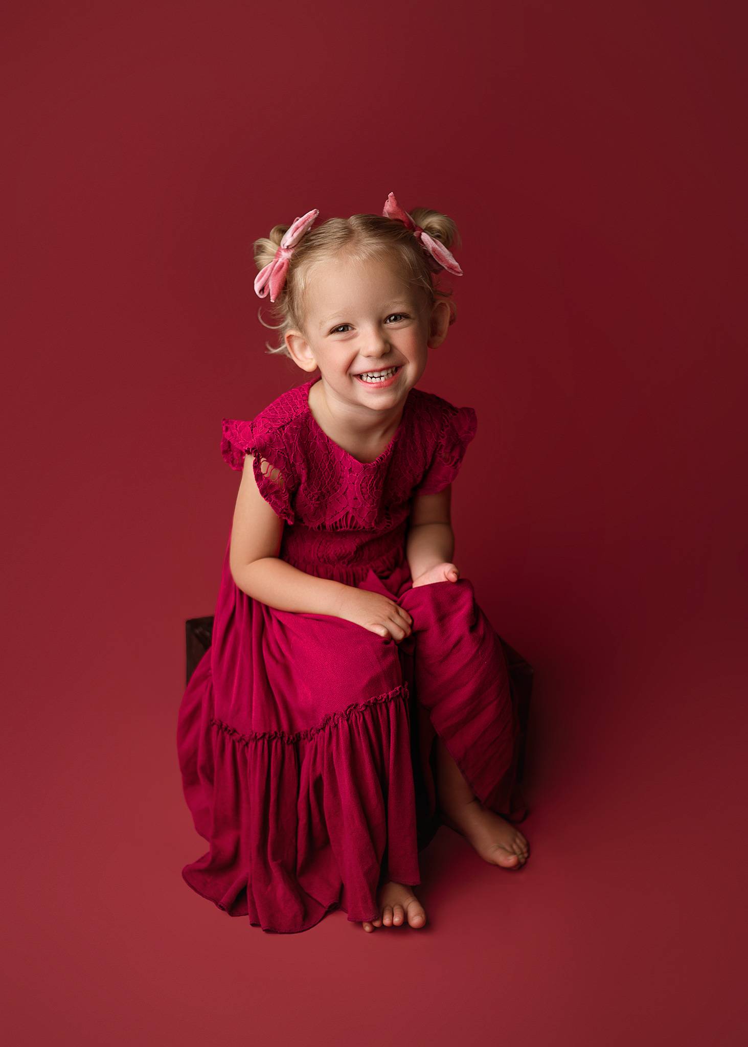 sweet big sister posing for milestone session in lincoln nebraska studio, baby photography lincoln, lincoln ne child photographer