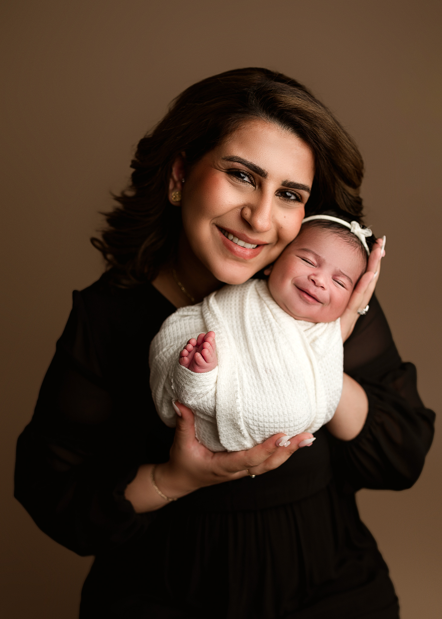 mom and baby girl smiling for parent poses during babies newborn session, parent pose ideas, neutral newborn photoshoot, nebraska newborn photographer, newborn photography omaha ne, lincoln ne newborn photography