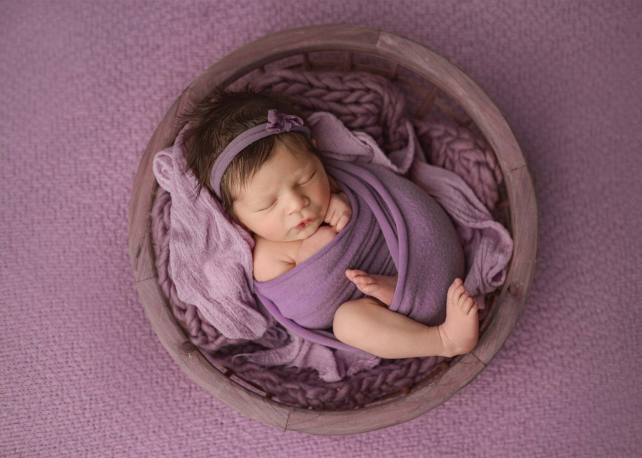 newborn girl in a bowl prop in lincoln nebraska newborn photography studio