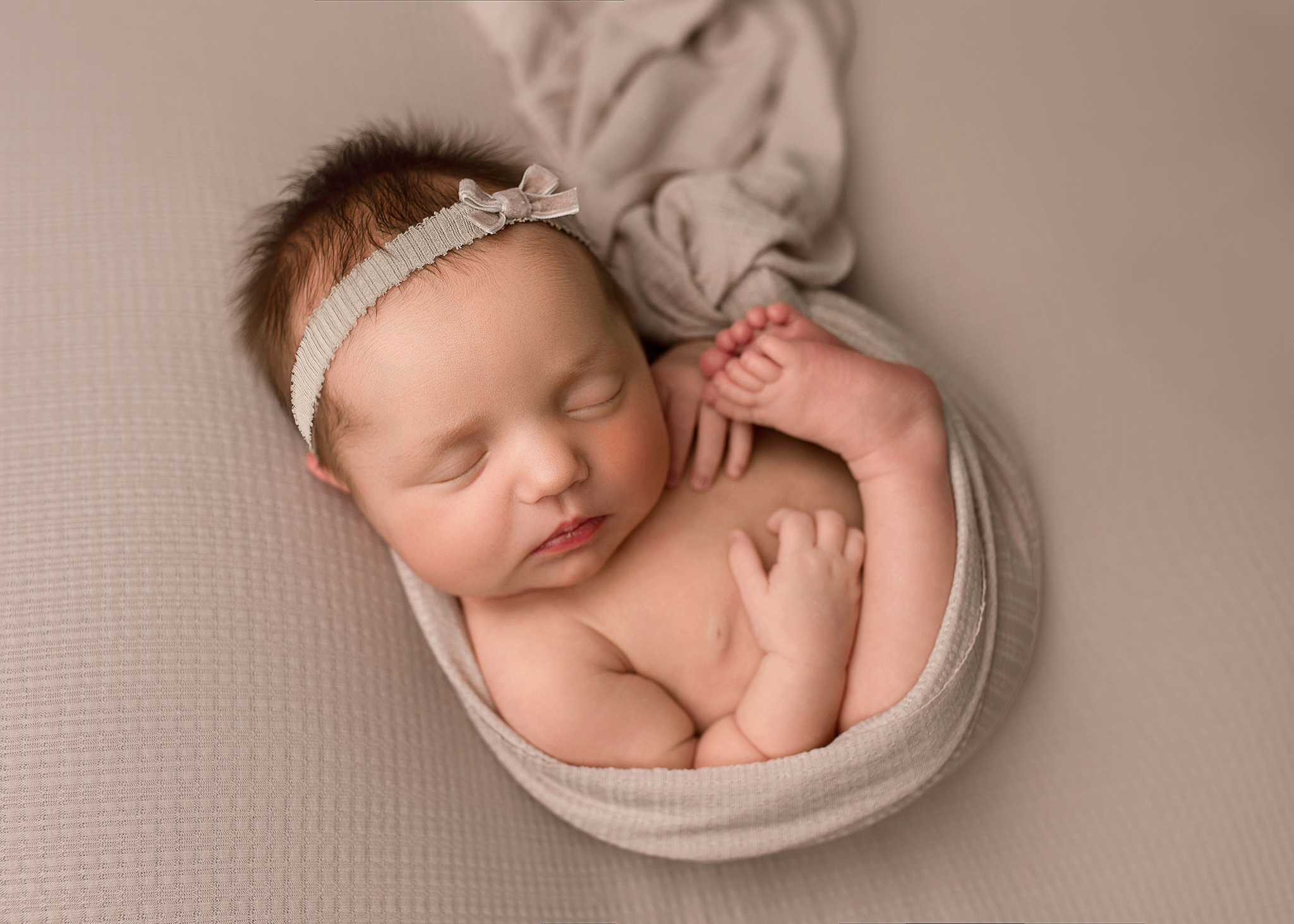 nebraska baby photographer, newborn girl wrapped in a pink wrap