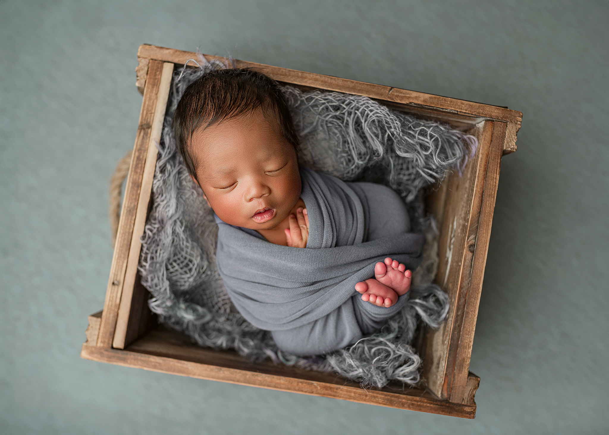 dusty blue newborn theme, baby boy in basket prop for professional photos